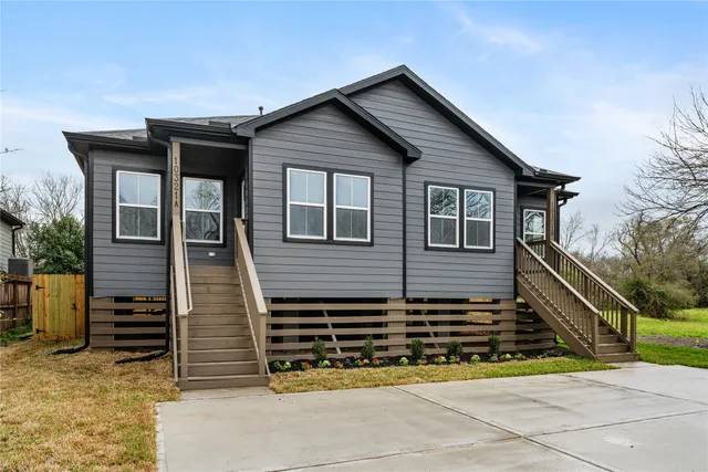 a view of a house with wooden fence