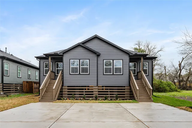 a view of a house with many windows and a table and chairs