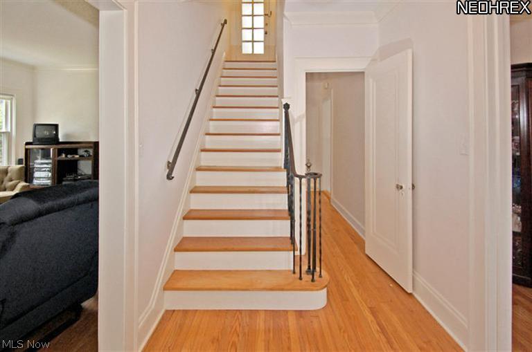 2581 Shaker Road Cleveland Heights, OH 44118 - Photo 4 of 25 View from entry way with living room to the left and dining room to the right. Kitchen doorway is in the distance. At the top of the stairway is a landing with the door to the 2nd floor sun room.