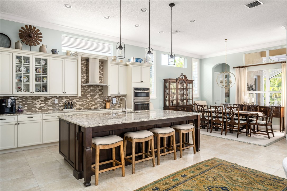 1101 River Wind Circle Vero Beach, FL 32967 - Photo 11 of 36 a large kitchen with a table and chairs