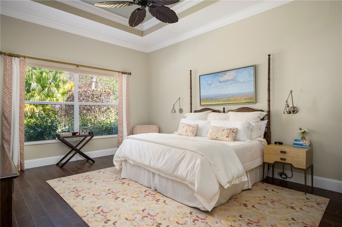 1101 River Wind Circle Vero Beach, FL 32967 - Photo 16 of 36 a bedroom with a bed a table and chair