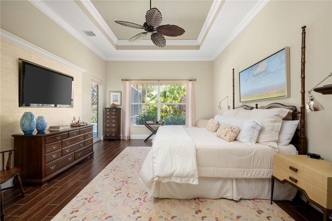 1101 River Wind Circle Vero Beach, FL 32967 - Photo 17 of 36 a bedroom with a bed and flat screen tv
