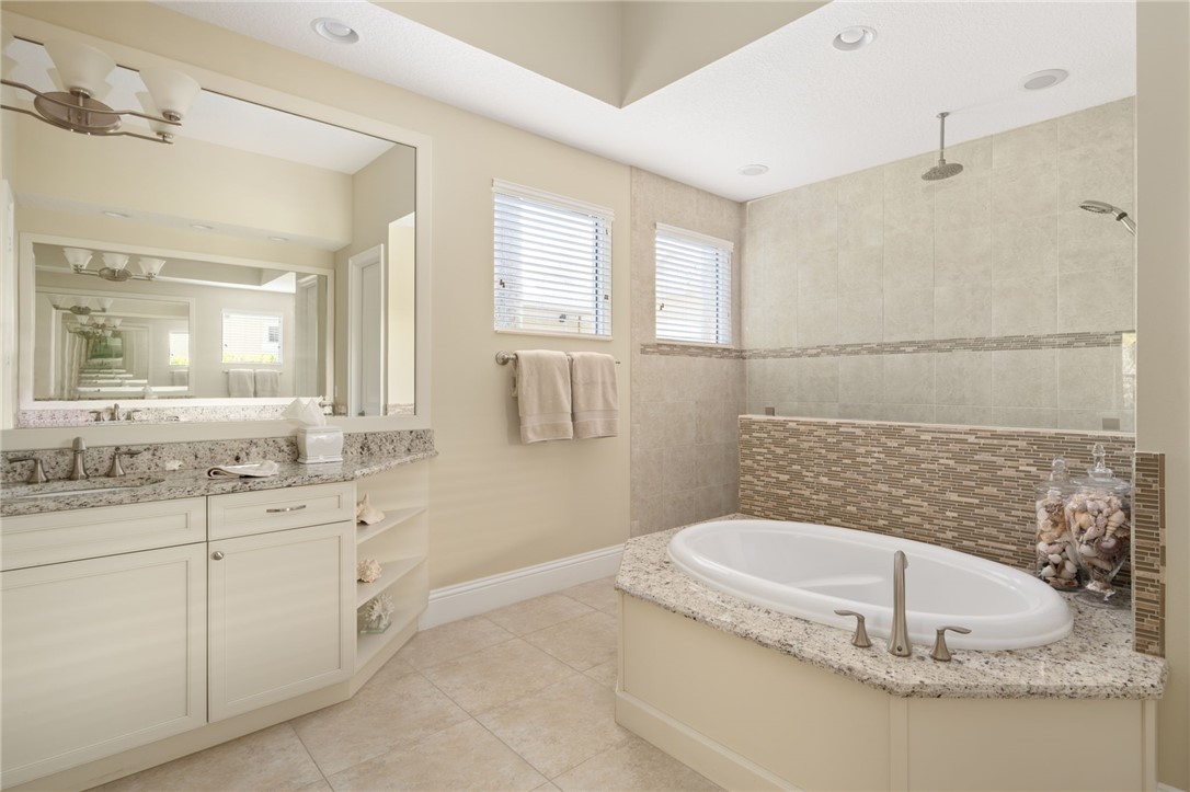 1101 River Wind Circle Vero Beach, FL 32967 - Photo 21 of 36 a bathroom with a sink and a mirror