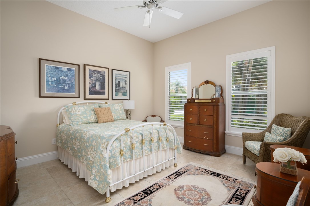 1101 River Wind Circle Vero Beach, FL 32967 - Photo 22 of 36 a bedroom with a bed and wooden floor