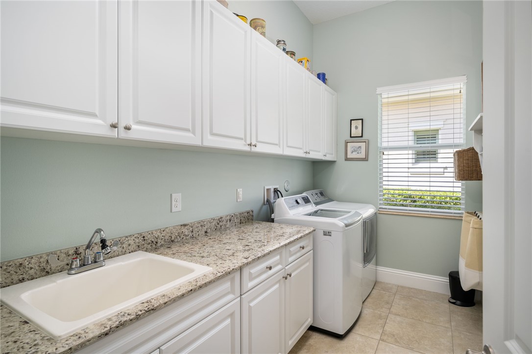 1101 River Wind Circle Vero Beach, FL 32967 - Photo 24 of 36 a utility room with a sink washer and dryer