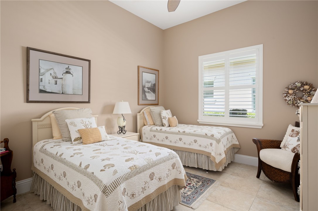 1101 River Wind Circle Vero Beach, FL 32967 - Photo 25 of 36 a bedroom with two beds and a couch