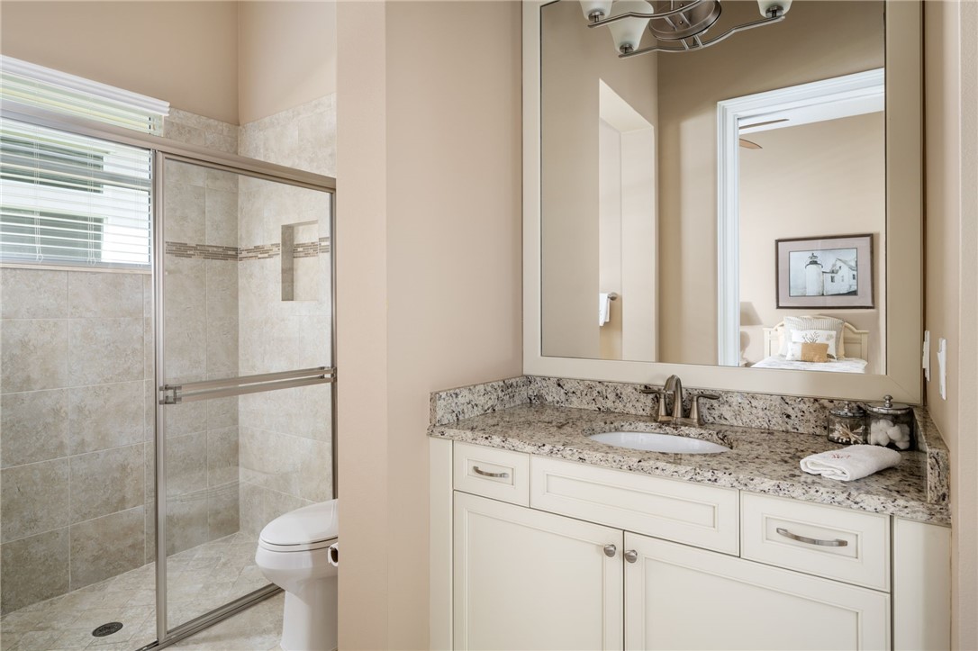 1101 River Wind Circle Vero Beach, FL 32967 - Photo 26 of 36 a bathroom with a granite countertop sink toilet and shower