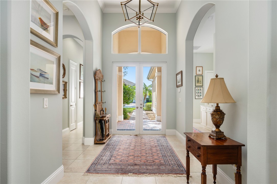 1101 River Wind Circle Vero Beach, FL 32967 - Photo 4 of 36 a view of a hallway with entryway wooden floor and front door