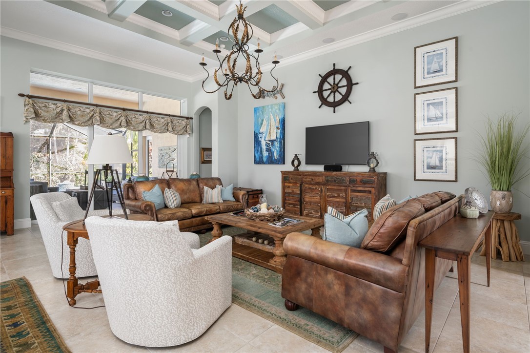 1101 River Wind Circle Vero Beach, FL 32967 - Photo 5 of 36 a living room with furniture a fireplace and a flat screen tv