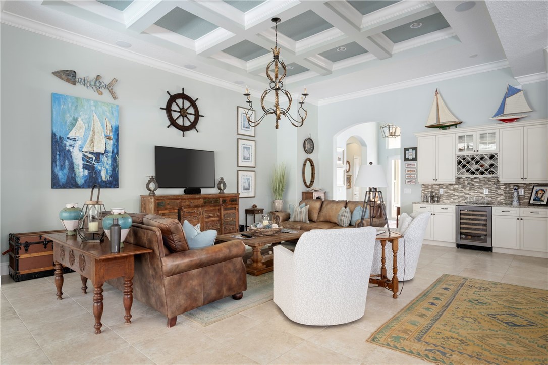 1101 River Wind Circle Vero Beach, FL 32967 - Photo 6 of 36 a living room with furniture and a flat screen tv
