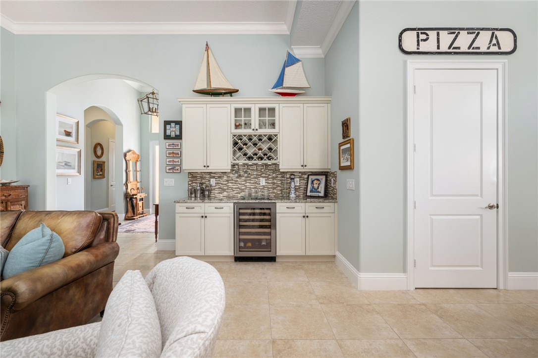 1101 River Wind Circle Vero Beach, FL 32967 - Photo 7 of 36 a living room with furniture and a kitchen