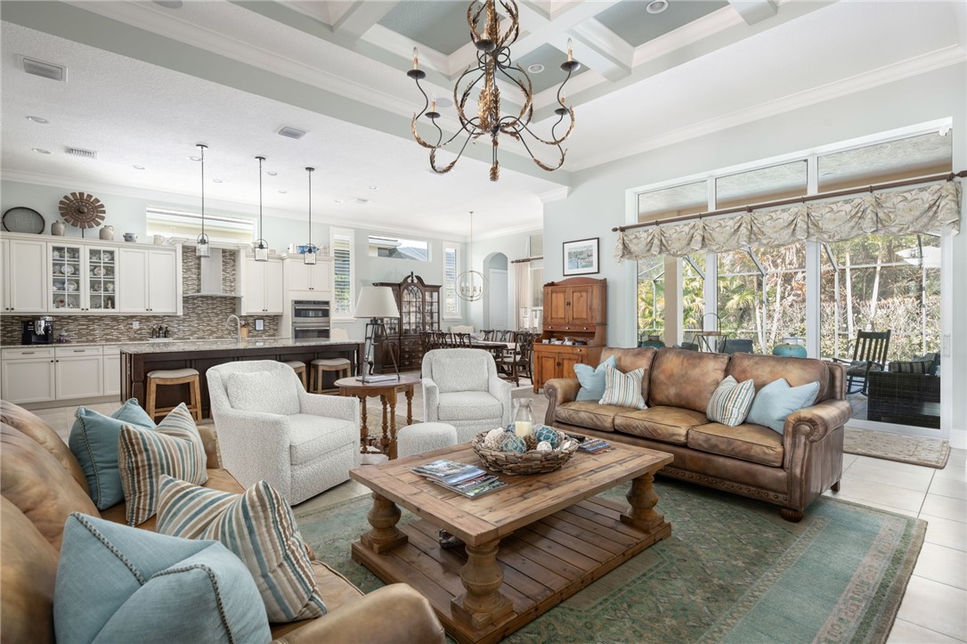 1101 River Wind Circle Vero Beach, FL 32967 - Photo 8 of 36 a living room with furniture kitchen view and a chandelier