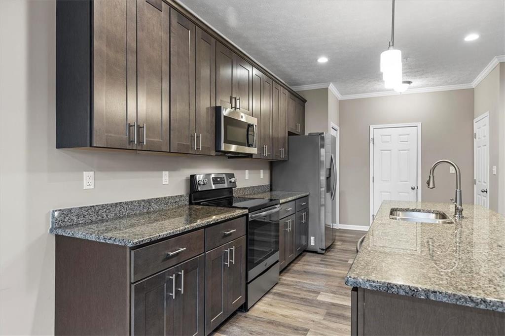 149 Lockheed Drive Coraopolis, PA 15108 - Photo 13 of 48 a kitchen with kitchen island granite countertop stainless steel appliances a sink stove and refrigerator