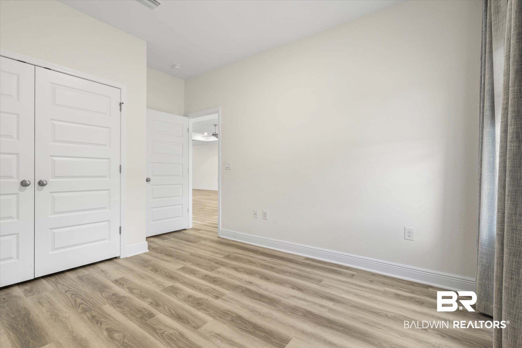 11229 Genuine Risk Circle Daphne, AL 36526 - Photo 16 of 46 Second bedroom with light wood-style floors and a closet