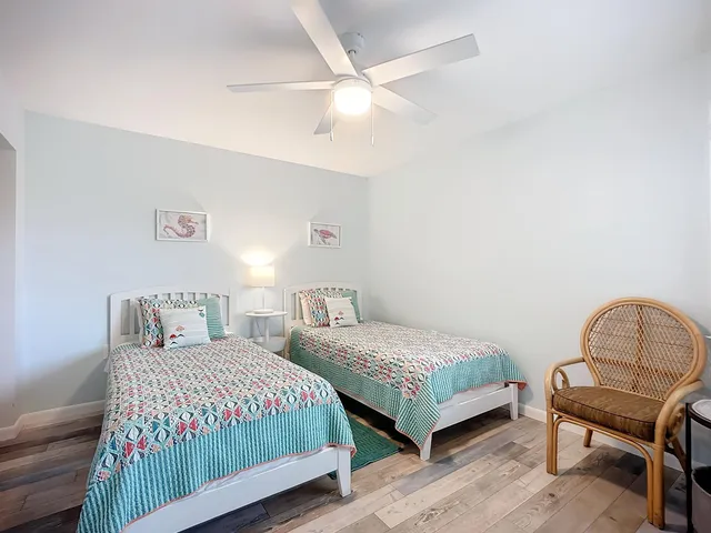 a bedroom with two beds and a flat screen tv