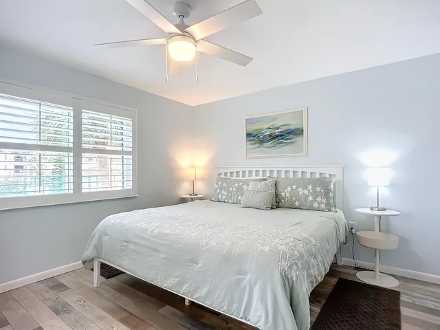 a bedroom with a large bed and a flat screen tv
