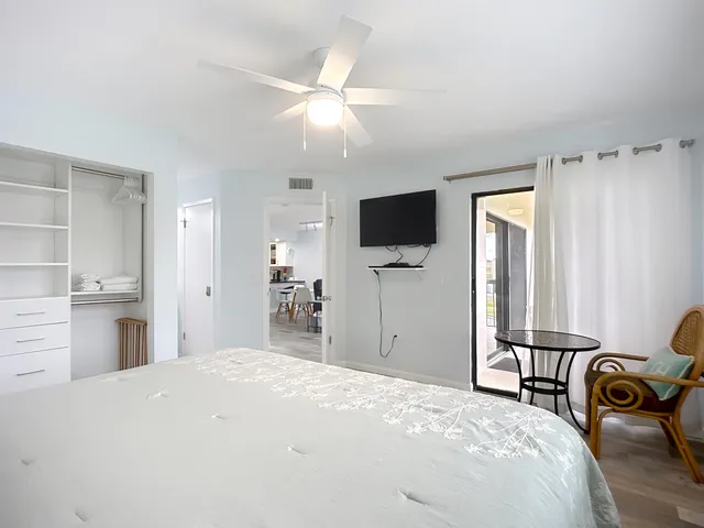 a bedroom with a bed and a flat screen tv