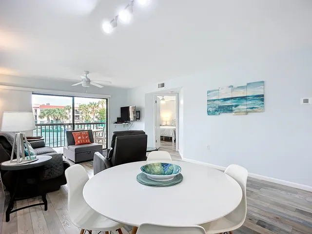 a kitchen with kitchen island a dining table and chairs