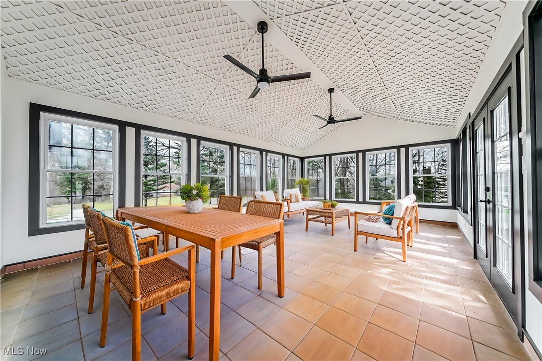 38470 Bainbridge Road Solon, OH 44139 - Photo 2 of 17 Sunroom featuring vaulted ceiling and ceiling fan (virtually staged).