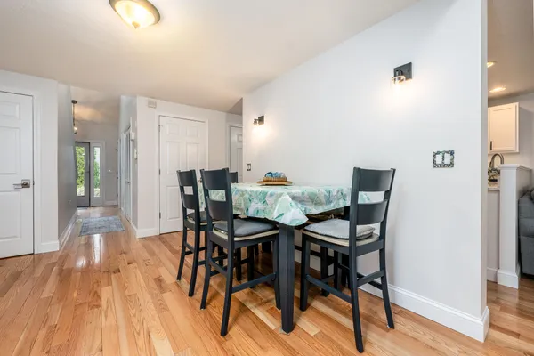 a view of a dining room with furniture and wooden floor