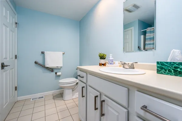 a bathroom with a sink toilet and mirror