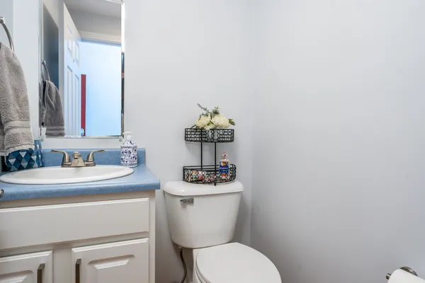 a bathroom with a sink mirror and toilet