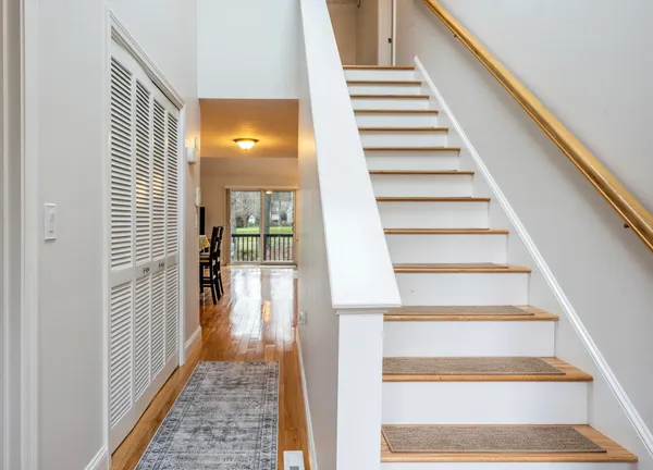 a view of a hallway with wooden floor and entryway