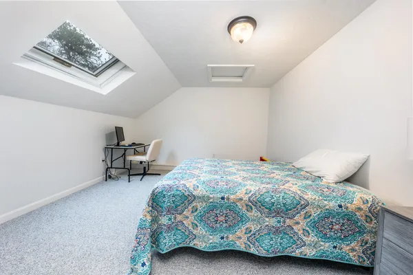 a bedroom with a bed a desk and chair