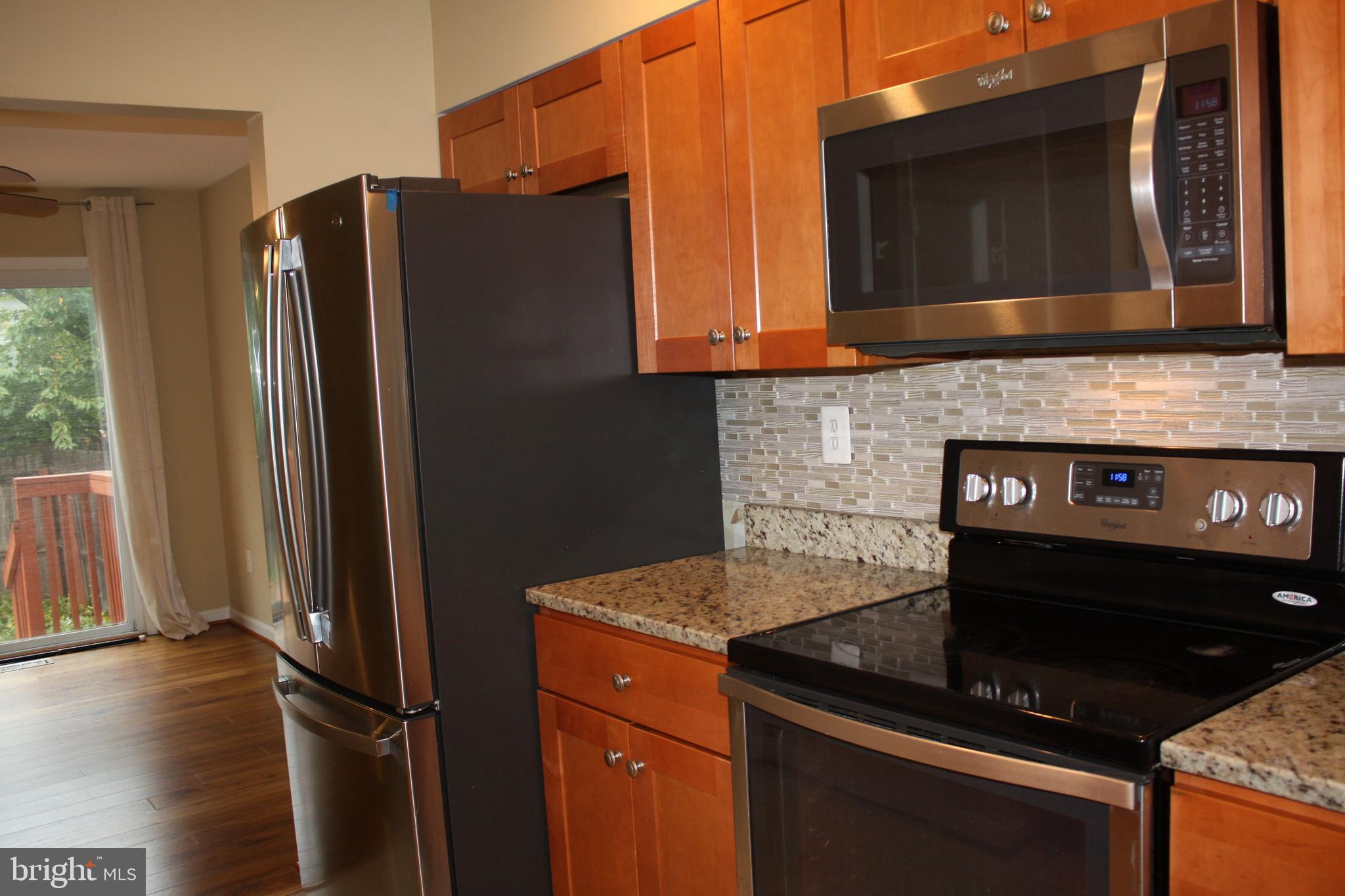 6261 Alforth Avenue Alexandria, VA 22315 - Photo 12 of 29 a kitchen with stainless steel appliances granite countertop a refrigerator and a stove top oven
