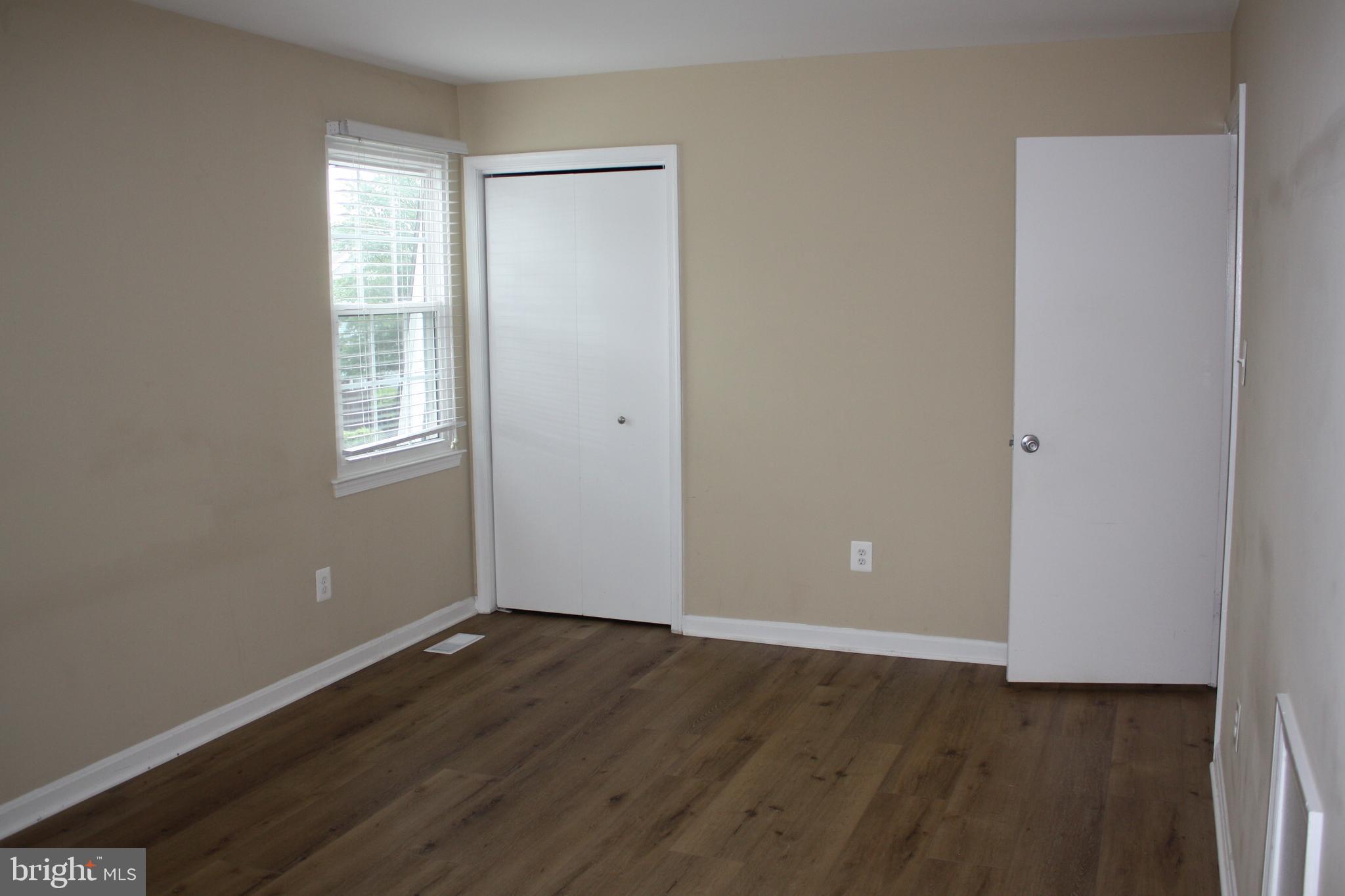 6261 Alforth Avenue Alexandria, VA 22315 - Photo 19 of 29 an empty room with wooden floor and windows