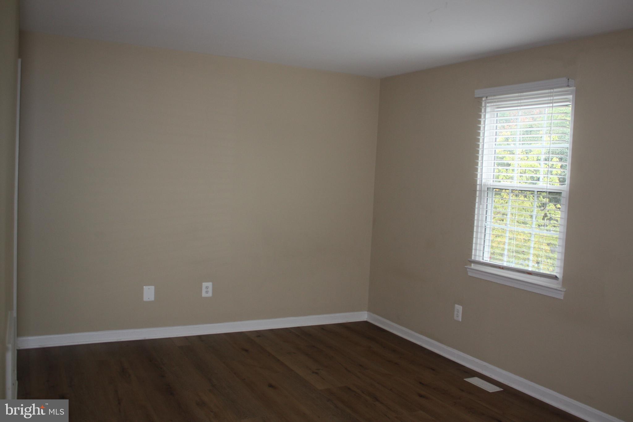 6261 Alforth Avenue Alexandria, VA 22315 - Photo 20 of 29 an empty room with wooden floor and windows