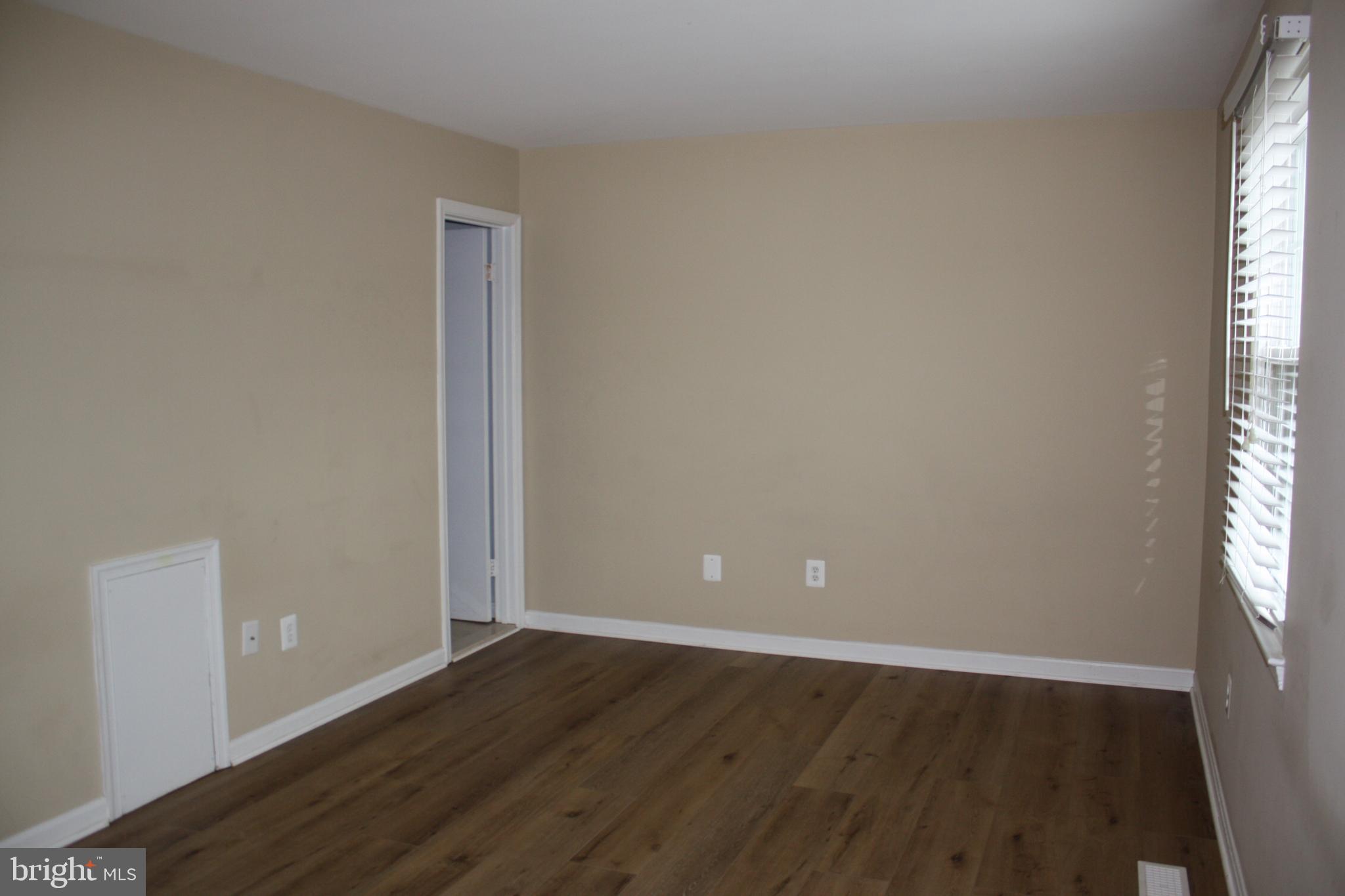 6261 Alforth Avenue Alexandria, VA 22315 - Photo 21 of 29 an empty room with wooden floor and windows