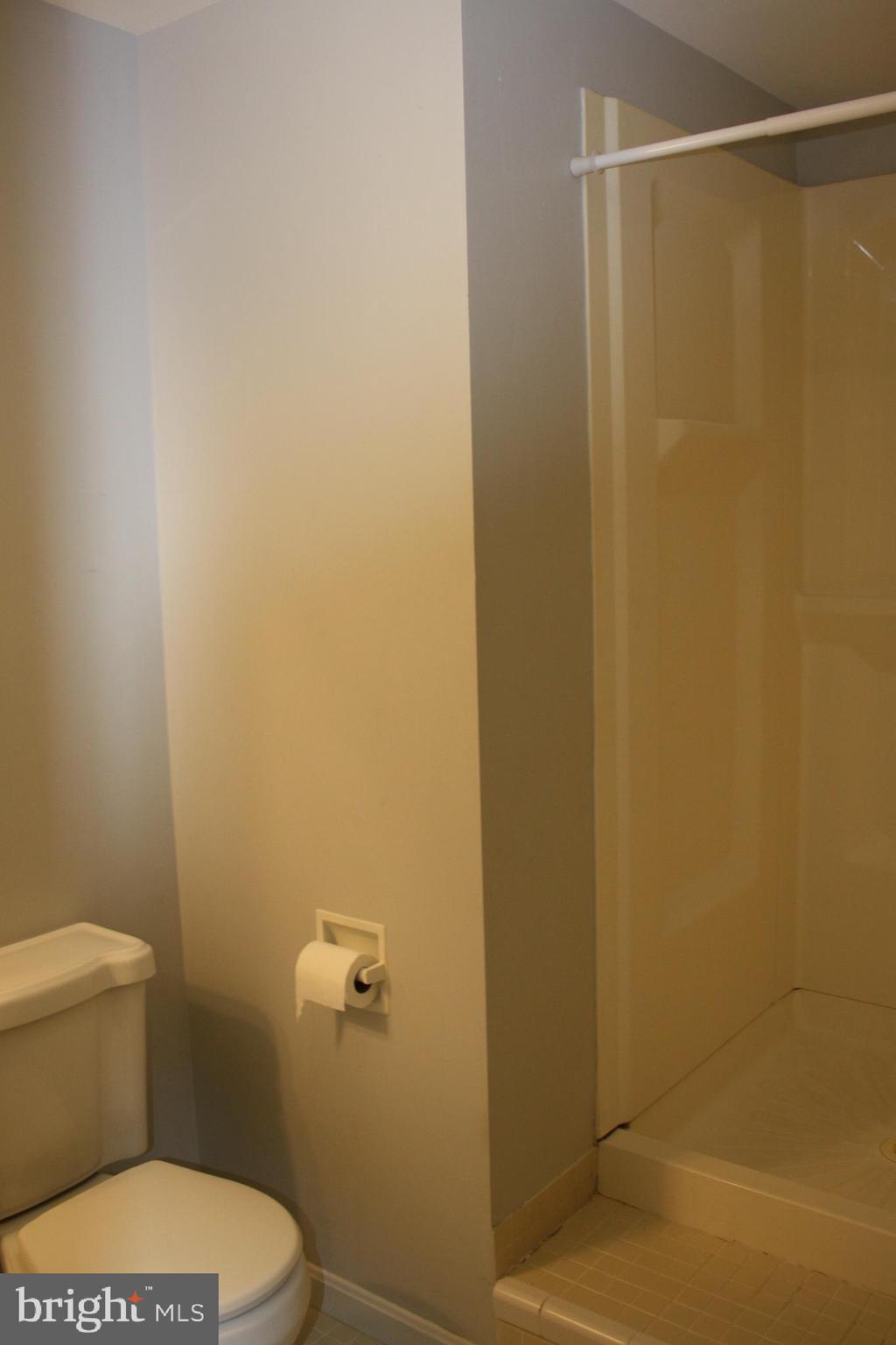 6261 Alforth Avenue Alexandria, VA 22315 - Photo 28 of 29 a white toilet sitting next to a shower curtain