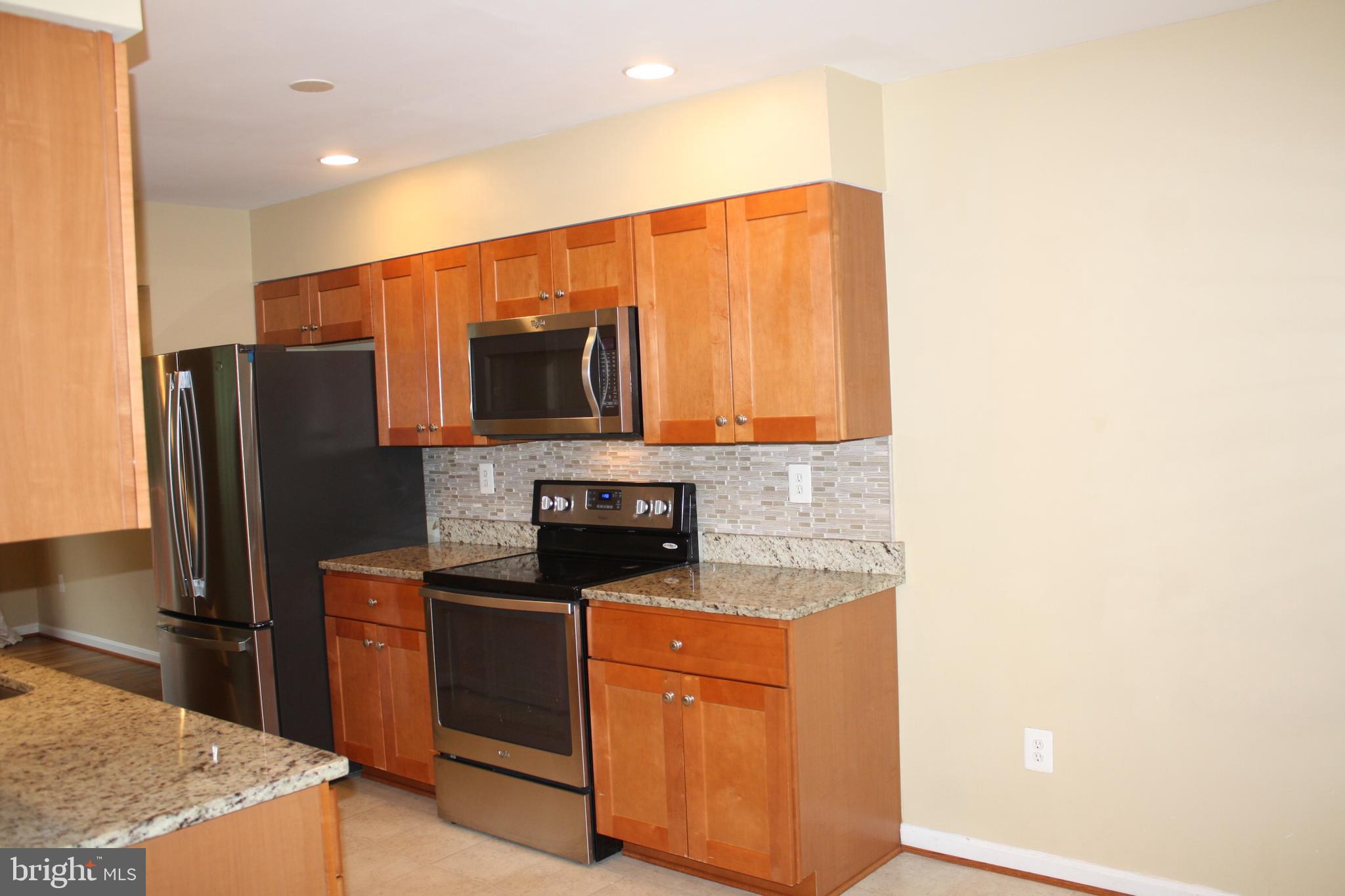 6261 Alforth Avenue Alexandria, VA 22315 - Photo 10 of 29 a kitchen with stainless steel appliances granite countertop a refrigerator a stove and a sink
