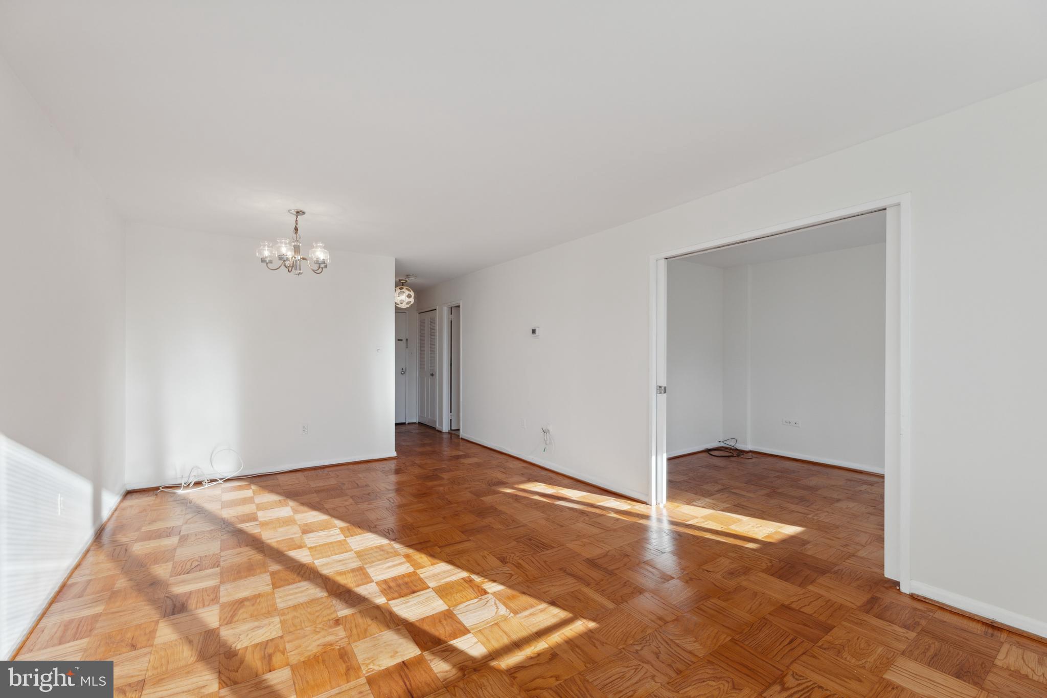 2939 Van Ness Street Northwest, Unit 1243 Washington, DC 20008 - Photo 13 of 33 a view of empty room with wooden floor