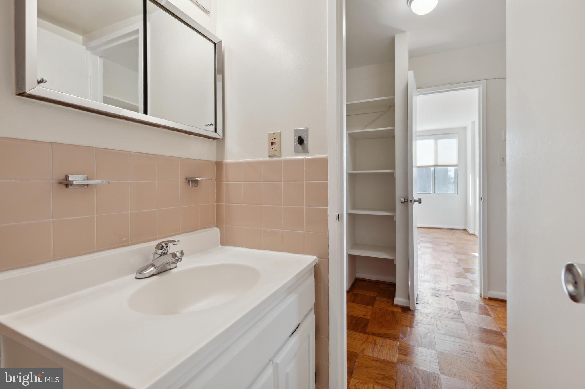 2939 Van Ness Street Northwest, Unit 1243 Washington, DC 20008 - Photo 19 of 33 a bathroom with a sink and a mirror