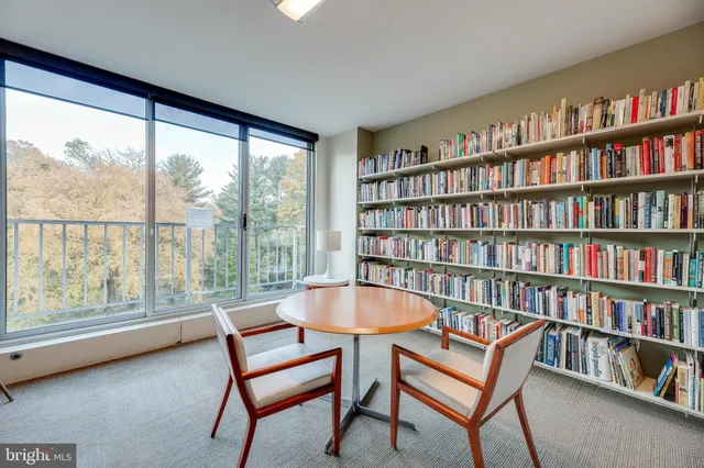 a kitchen with white cabinets and refrigerator