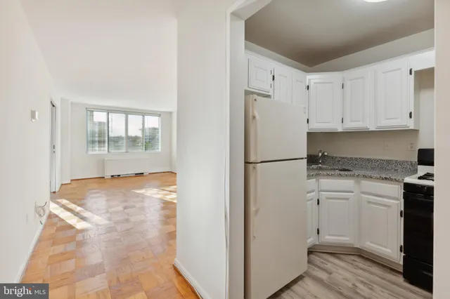 a kitchen with white cabinets and white appliances