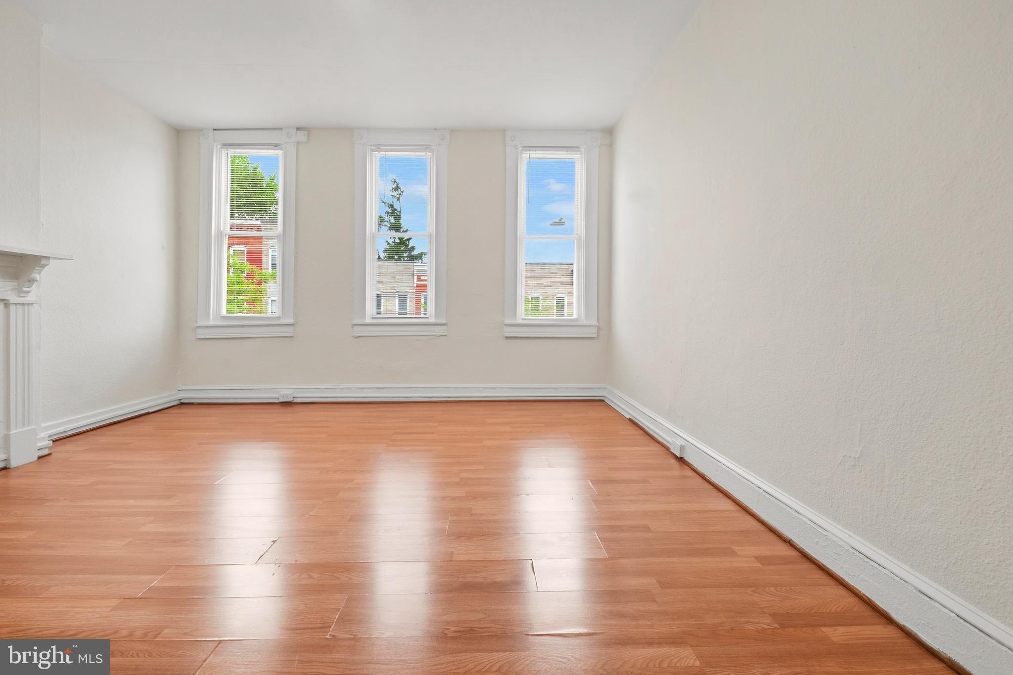 2008 Division Street Baltimore, MD 21217 - Photo 14 of 21 an empty room with wooden floor and windows