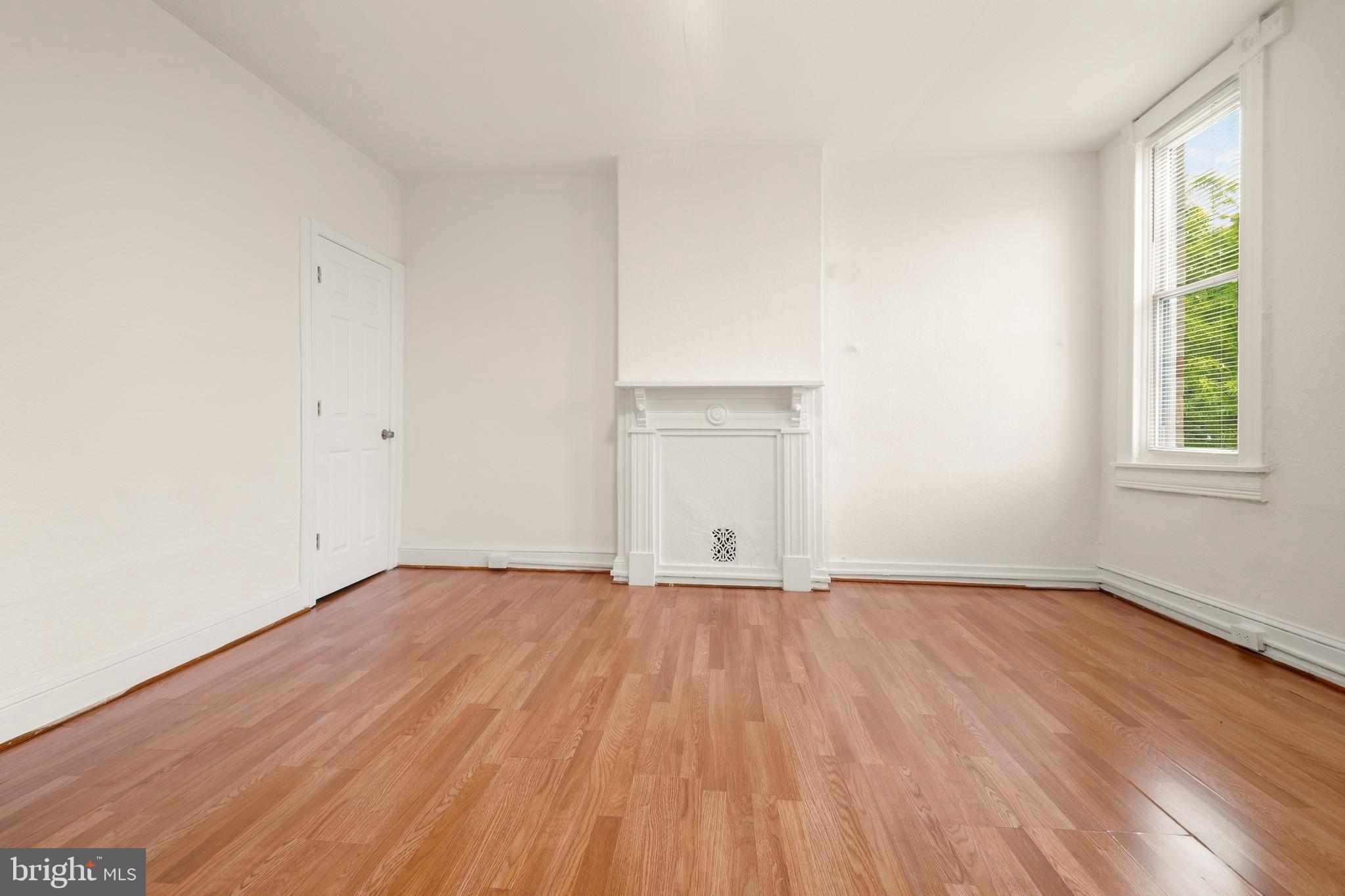 2008 Division Street Baltimore, MD 21217 - Photo 15 of 21 an empty room with wooden floor and windows
