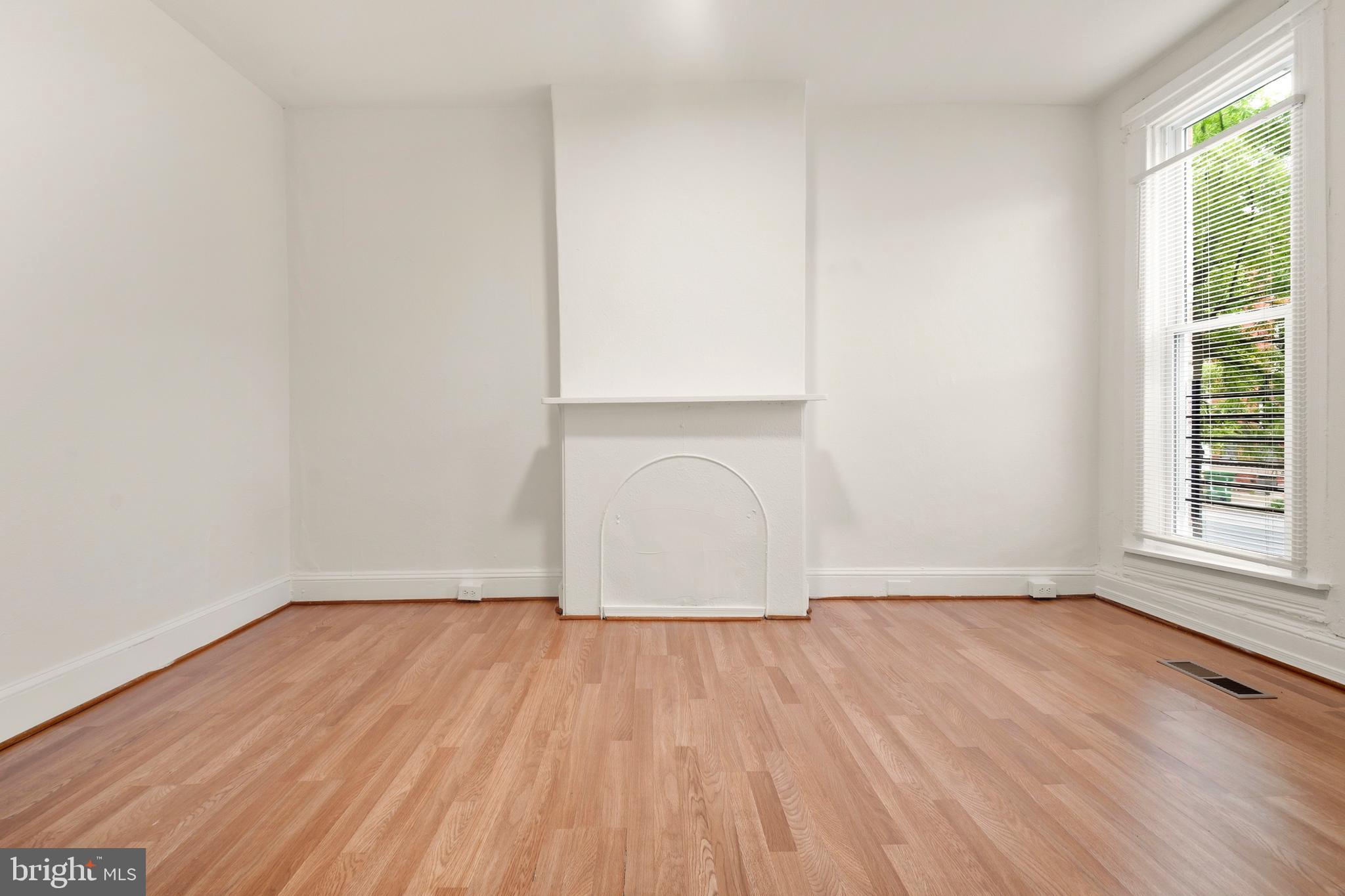 2008 Division Street Baltimore, MD 21217 - Photo 3 of 21 an empty room with wooden floor and windows