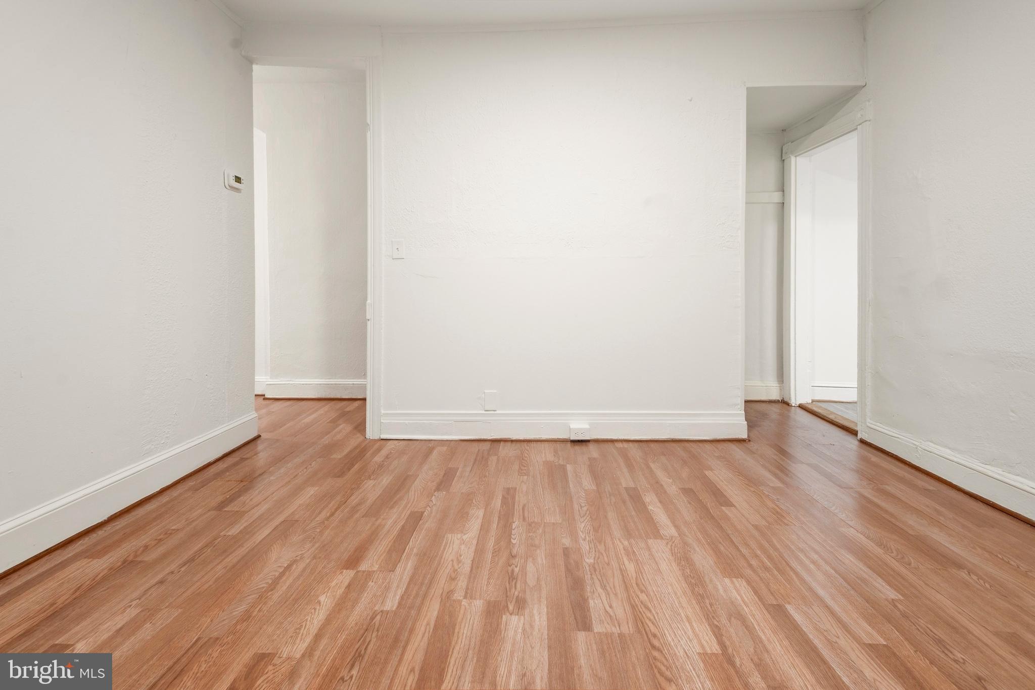 2008 Division Street Baltimore, MD 21217 - Photo 4 of 21 a view of an empty room with wooden floor