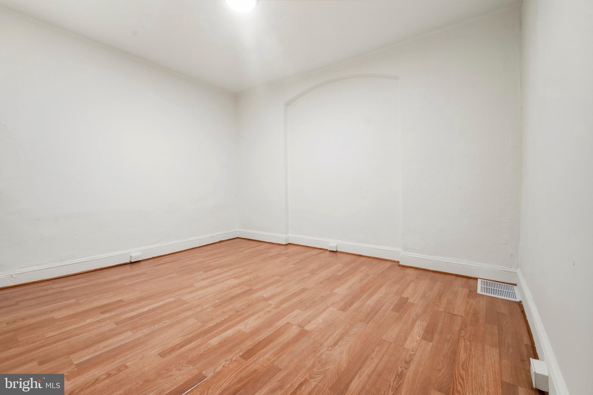 2008 Division Street Baltimore, MD 21217 - Photo 5 of 21 a view of an empty room with wooden floor