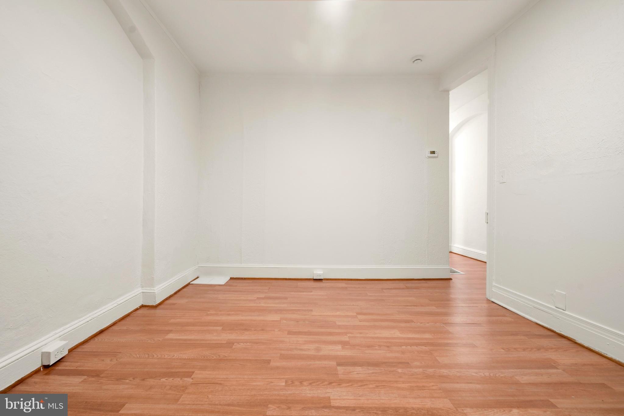 2008 Division Street Baltimore, MD 21217 - Photo 6 of 21 a view of an empty room with wooden floor