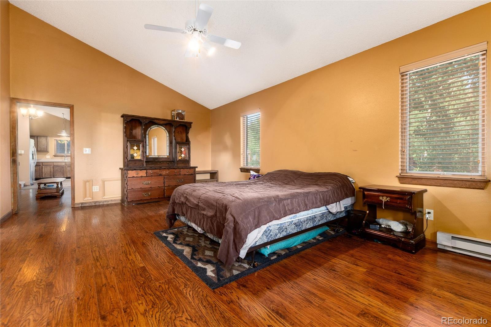 65 Silver Springs Road Bailey, CO 80421 - Photo 12 of 45 a spacious bedroom with a bed a dresser and wooden floor