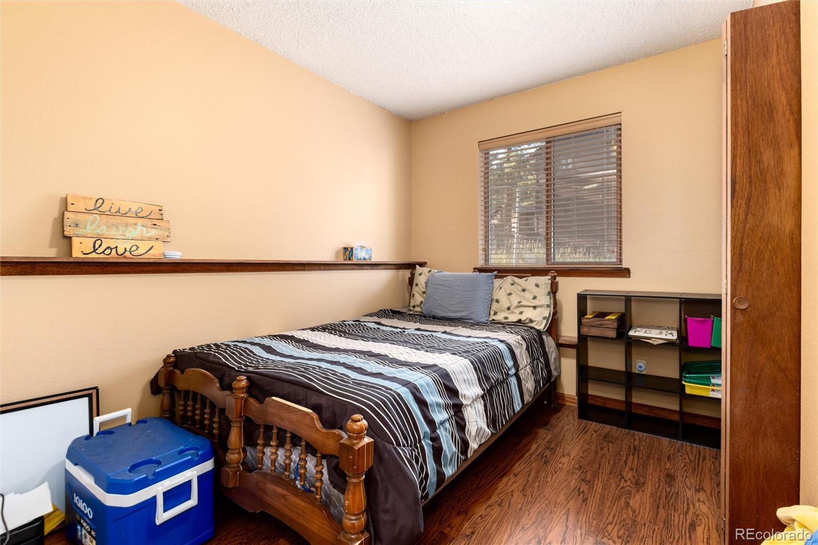 65 Silver Springs Road Bailey, CO 80421 - Photo 12 of 38 a bedroom with a bed and wooden floor
