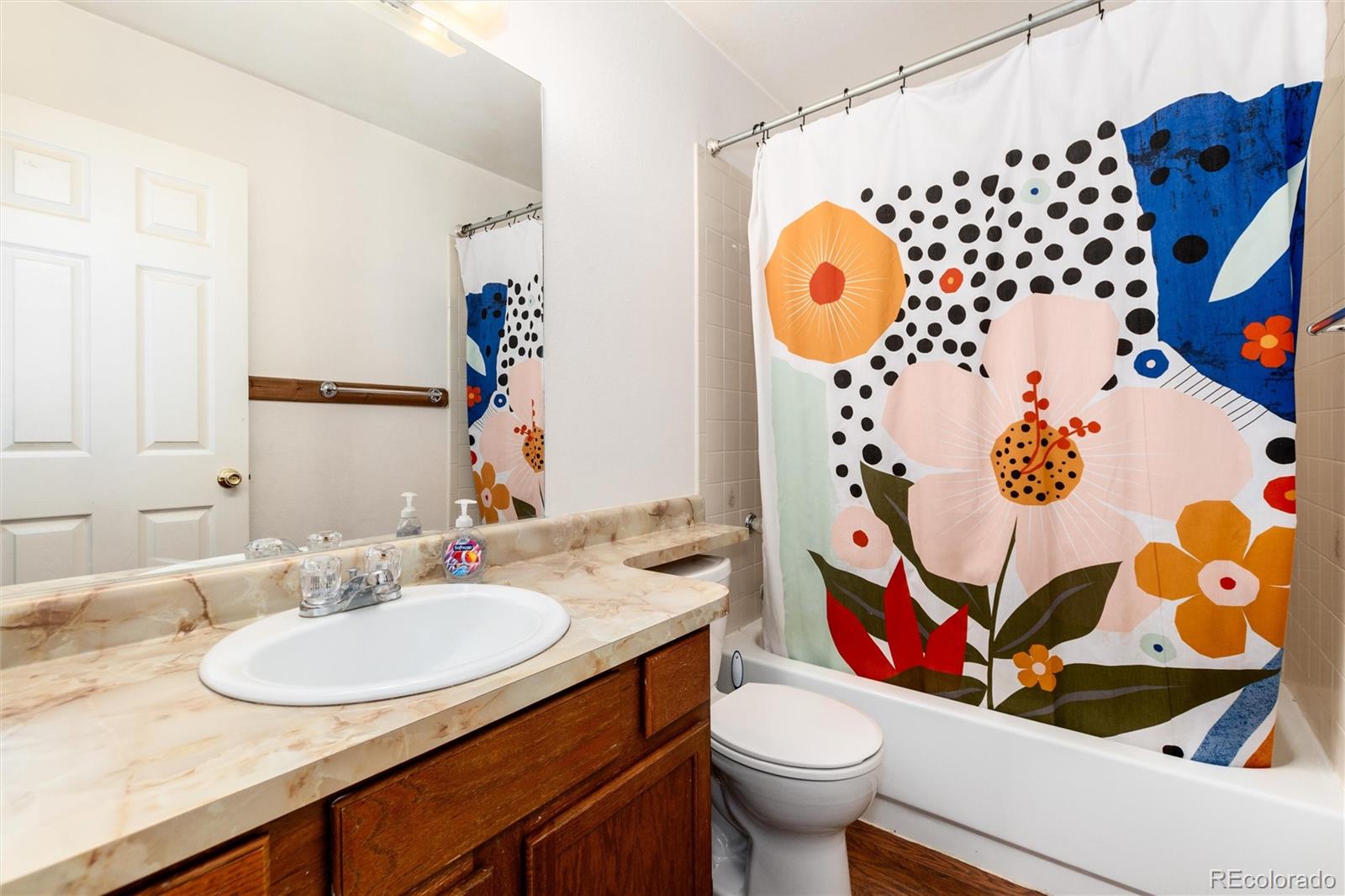 65 Silver Springs Road Bailey, CO 80421 - Photo 16 of 45 a bathroom with a sink and mirror with toilet