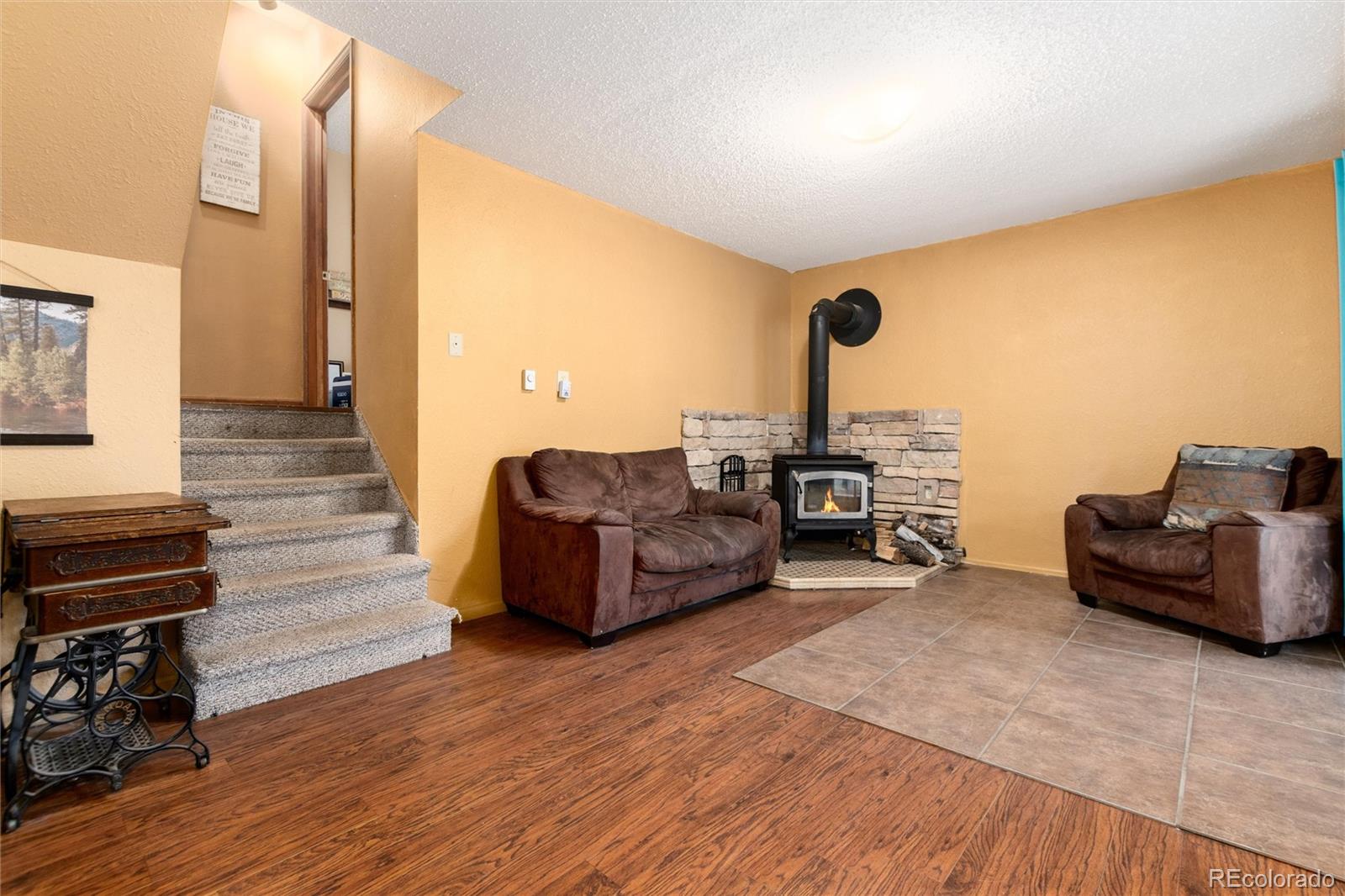 65 Silver Springs Road Bailey, CO 80421 - Photo 17 of 38 a living room with furniture and a wooden floor