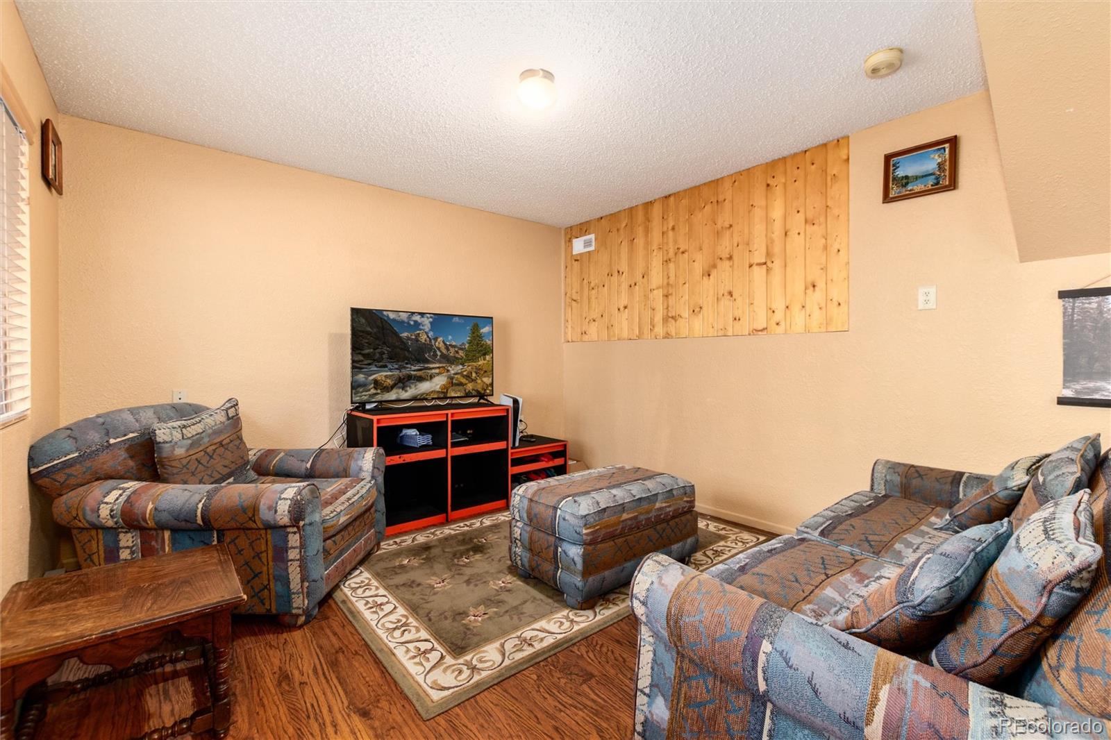 65 Silver Springs Road Bailey, CO 80421 - Photo 20 of 45 a living room with furniture and a flat screen tv