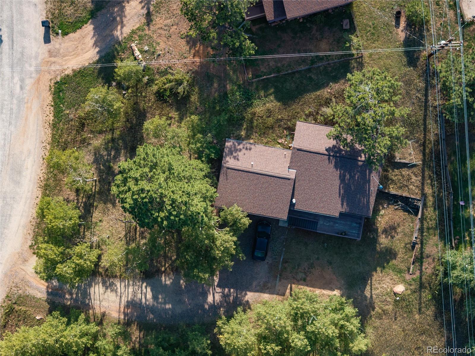 65 Silver Springs Road Bailey, CO 80421 - Photo 36 of 45 an aerial view of a house with garden space sitting space and swimming pool